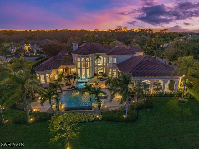 view of front facade with a front lawn, a tile roof, a patio, an outdoor pool, and an in ground hot tub