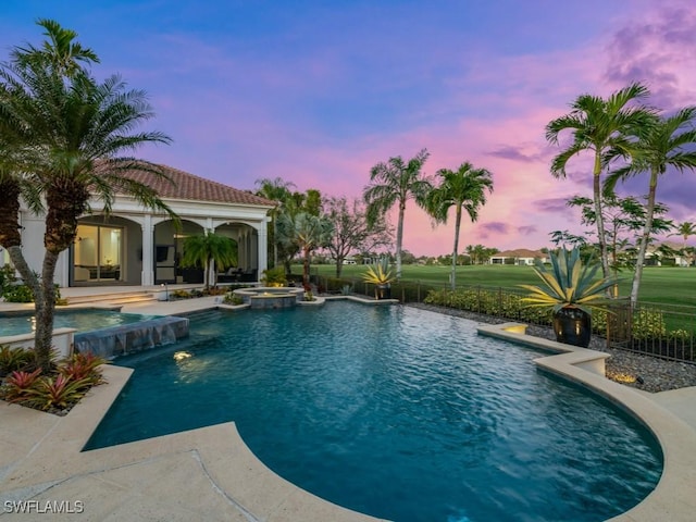 view of swimming pool featuring an exterior structure, a patio, a pool with connected hot tub, and an outdoor structure