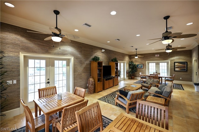 dining room featuring french doors, crown molding, a wealth of natural light, and ceiling fan