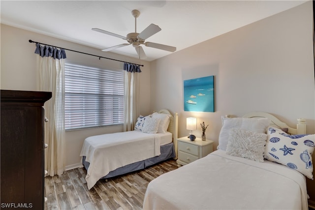 bedroom with ceiling fan and wood-type flooring