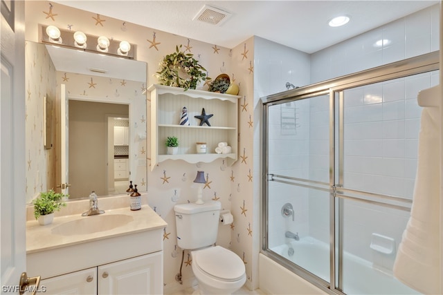 full bathroom with vanity, toilet, and shower / bath combination with glass door