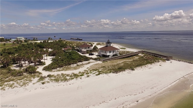 birds eye view of property with a view of the beach and a water view