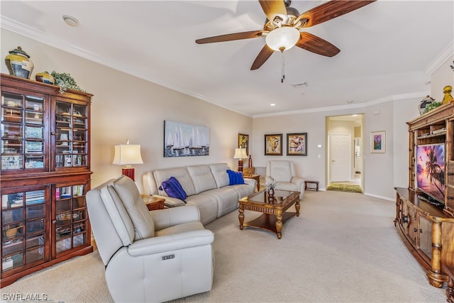 living room with crown molding, ceiling fan, and light colored carpet