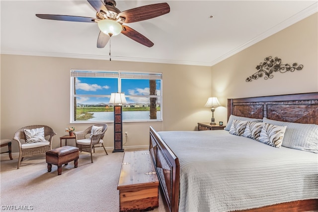 carpeted bedroom with a water view, ceiling fan, and crown molding