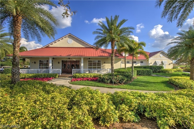 exterior space with covered porch and a yard