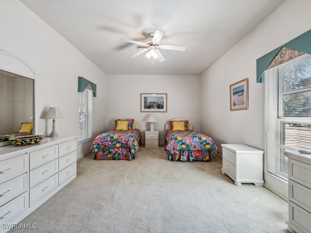 bedroom featuring light carpet and ceiling fan