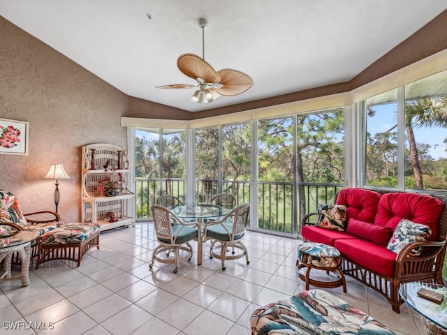 sunroom featuring ceiling fan, a wealth of natural light, and vaulted ceiling