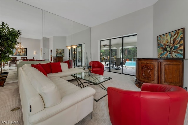 living room with a notable chandelier and light colored carpet