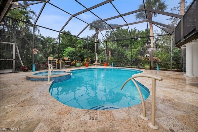 view of swimming pool with a lanai, a patio area, and an in ground hot tub