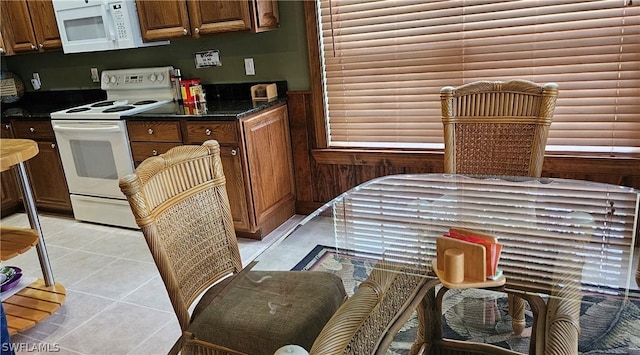 kitchen featuring light tile patterned floors and white appliances