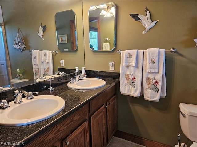 bathroom with vanity, toilet, and tile patterned flooring