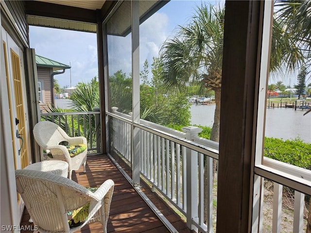 sunroom with a water view and a healthy amount of sunlight