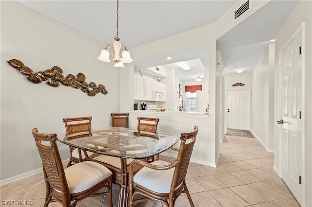 dining area with light tile flooring and a notable chandelier