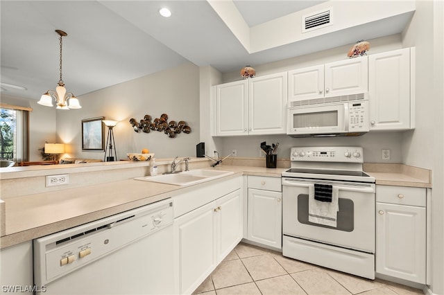 kitchen with a chandelier, decorative light fixtures, white appliances, white cabinets, and sink