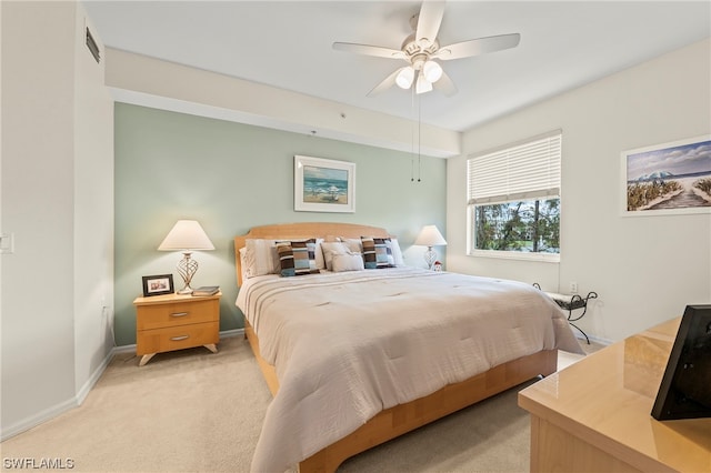 bedroom featuring light colored carpet and ceiling fan