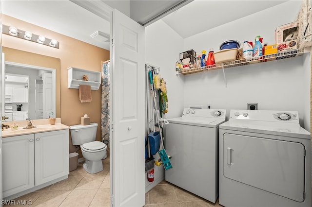 laundry room featuring light tile floors, washing machine and dryer, hookup for an electric dryer, and sink