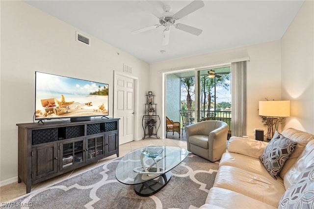 living room with light tile flooring and ceiling fan