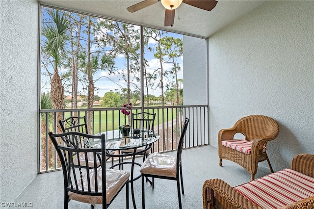 sunroom featuring ceiling fan