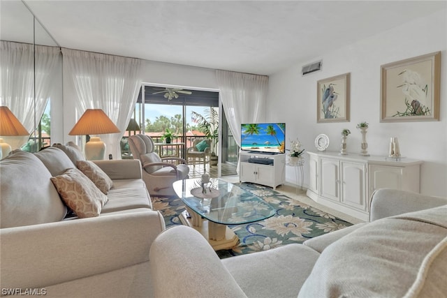 living room with plenty of natural light and ceiling fan