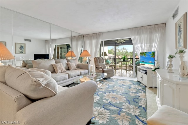 carpeted living room featuring ceiling fan