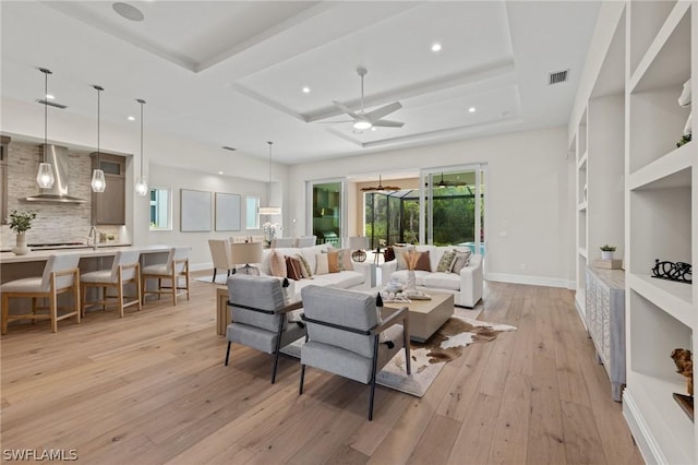 living room featuring ceiling fan and light hardwood / wood-style flooring