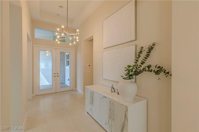 interior space with french doors, an inviting chandelier, and light tile patterned flooring