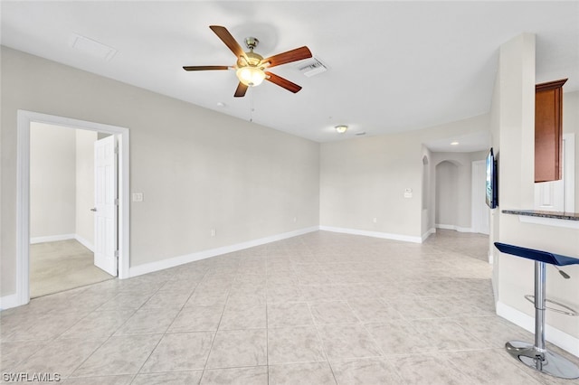 tiled empty room with ceiling fan