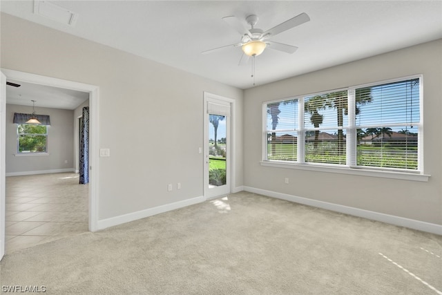 empty room featuring ceiling fan and light colored carpet