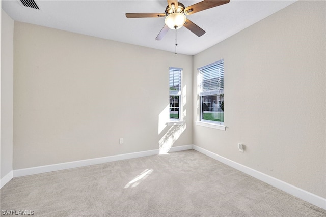 empty room featuring carpet floors and ceiling fan