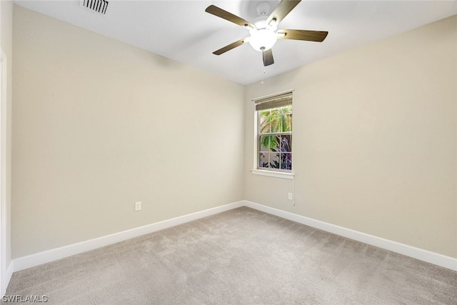 carpeted spare room with ceiling fan