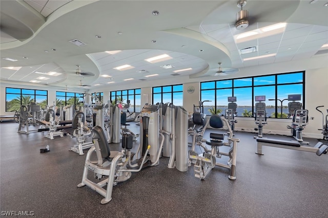 workout area with a drop ceiling and ceiling fan