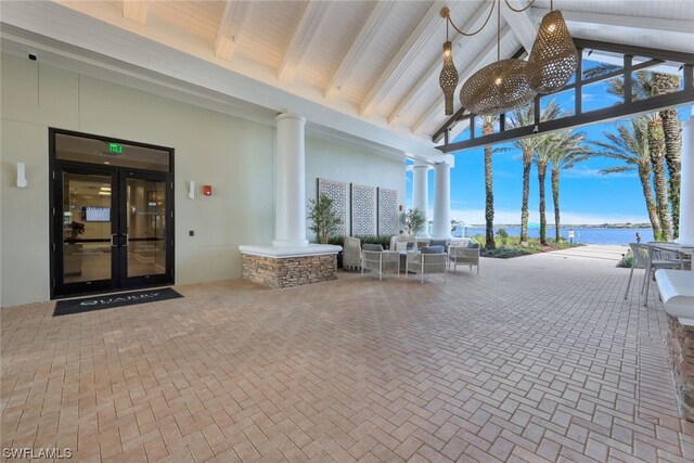 view of patio / terrace featuring outdoor lounge area, french doors, and a water view