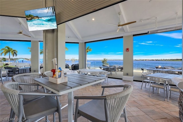 view of patio featuring a water view and ceiling fan