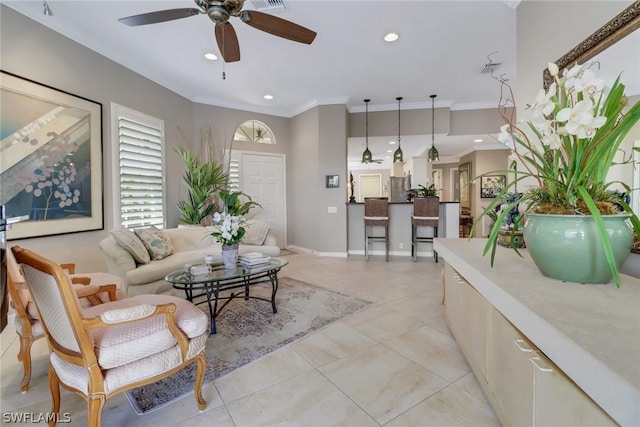 living room with ornamental molding, plenty of natural light, light tile patterned flooring, and ceiling fan