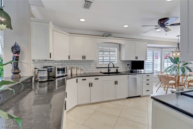 kitchen with tasteful backsplash, dishwasher, white cabinets, and crown molding