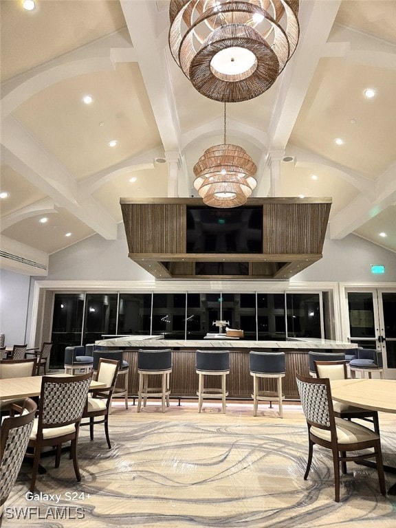 bar featuring an inviting chandelier, beam ceiling, and high vaulted ceiling