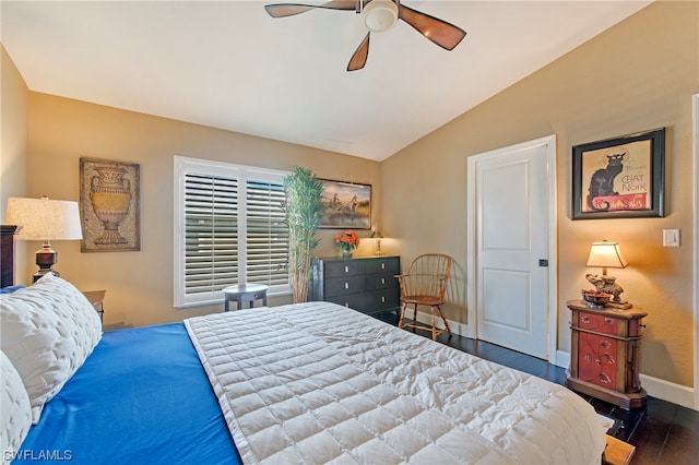 bedroom with dark hardwood / wood-style floors, vaulted ceiling, and ceiling fan