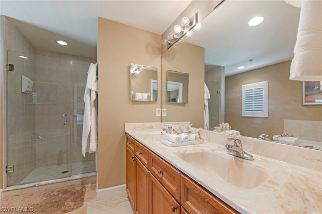 bathroom with an enclosed shower, tile flooring, and vanity with extensive cabinet space