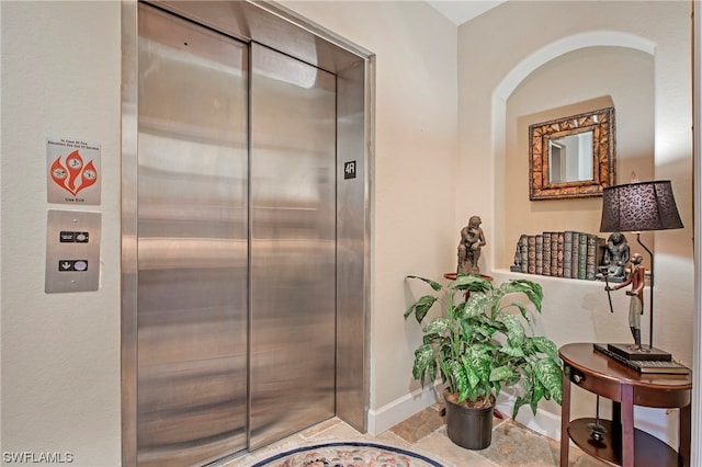 interior details featuring tile floors and elevator