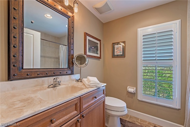 bathroom featuring vanity, tile floors, and toilet