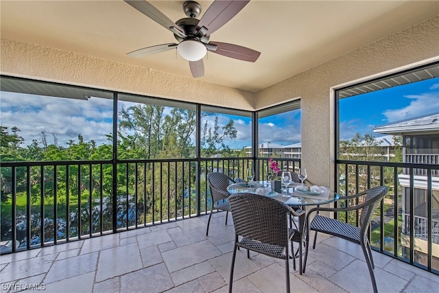 sunroom featuring ceiling fan