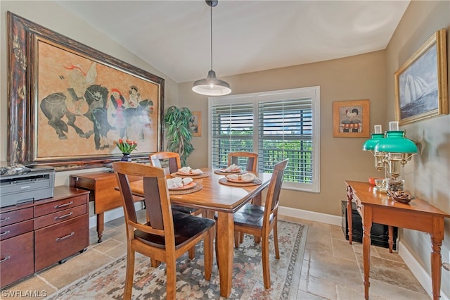 tiled dining area with lofted ceiling