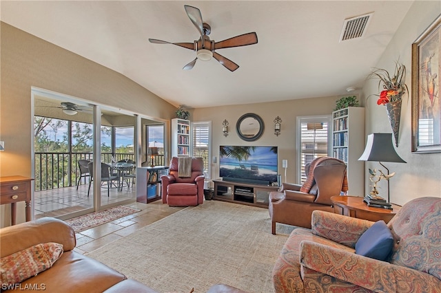 living room featuring light tile flooring, lofted ceiling, and ceiling fan