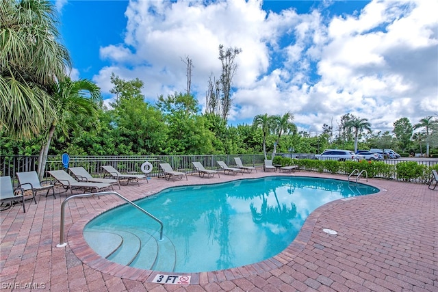 view of swimming pool featuring a patio area