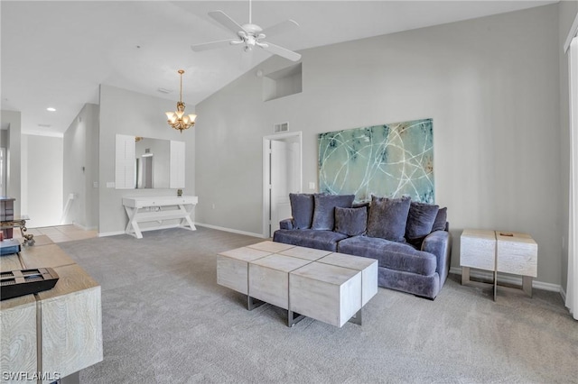 carpeted living room featuring high vaulted ceiling and ceiling fan with notable chandelier