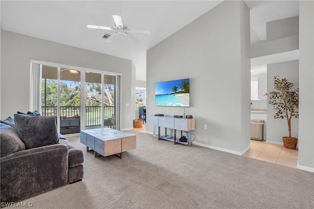 carpeted living room featuring ceiling fan and high vaulted ceiling