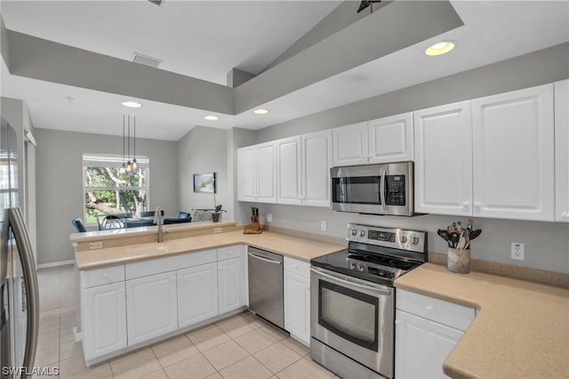 kitchen featuring stainless steel appliances, sink, white cabinets, and kitchen peninsula