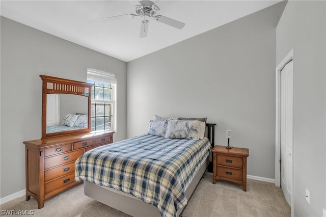 carpeted bedroom featuring ceiling fan and a closet