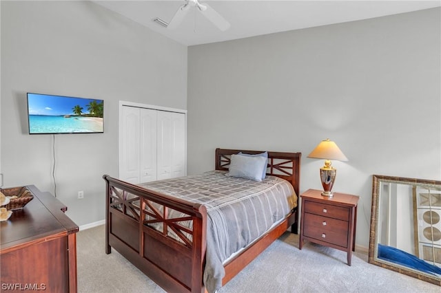 carpeted bedroom featuring ceiling fan and a closet