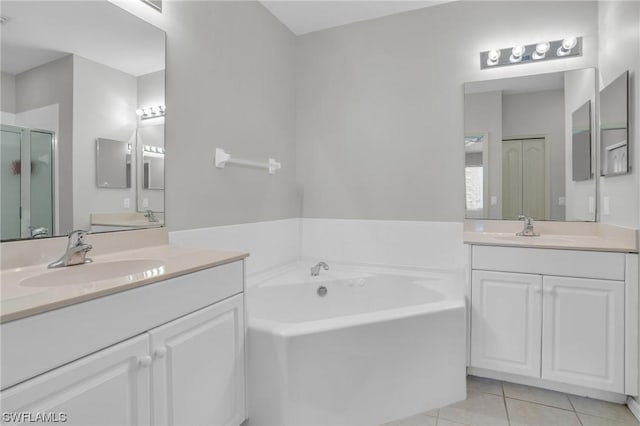 bathroom featuring vanity, shower with separate bathtub, and tile patterned floors